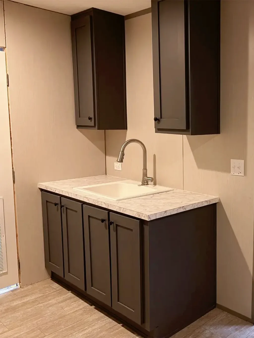Mud sink with overhead cabinets Image